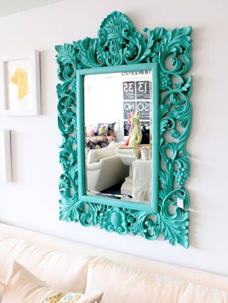 32 Mirror Decorating Ideas - Transform Home With Mirrors 15 Ornate turquoise decorative mirror with floral designs, 40x30 inches, enhancing a contemporary living room with vibrant color and light reflection.