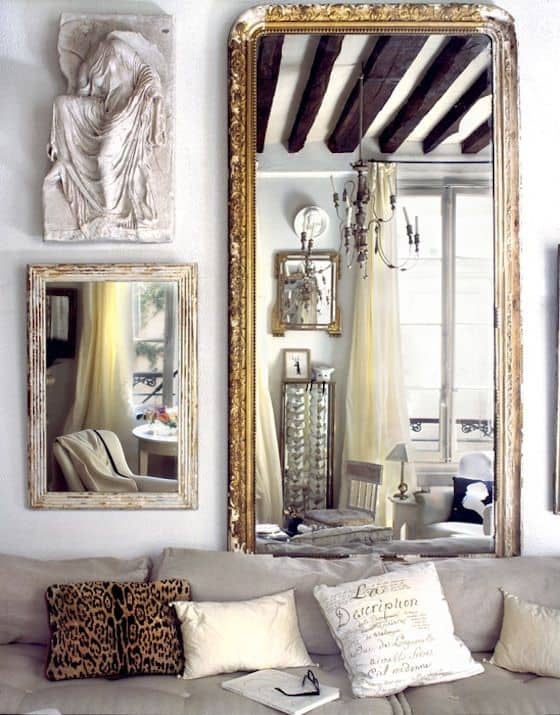 32 Mirror Decorating Ideas - Transform Home With Mirrors 16 Two large ornate mirrors flank a plush couch, reflecting light from sheer curtains, enhancing this stylish living room decor.