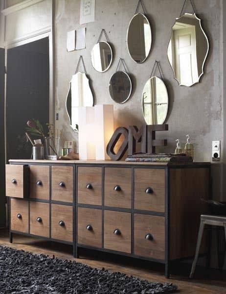 32 Mirror Decorating Ideas - Transform Home With Mirrors 17 Decorative mirrors of various shapes surround a dark wooden sideboard, enhancing light and depth in a modern living room.