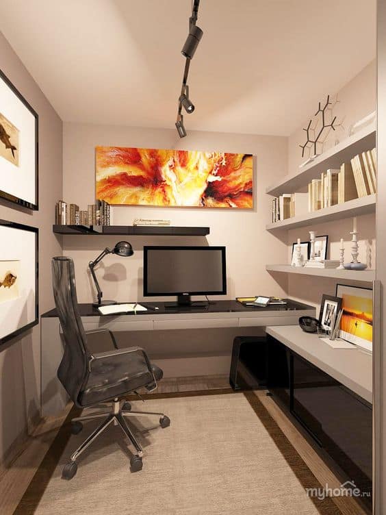 Compact home office featuring a 60-inch gray laminate desk with a black storage unit, ergonomic chair, minimalist shelves, and vibrant artwork.