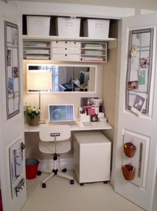 Compact home office design integrated into a closet, featuring a white desk, rolling chair, and organized shelving for storage solutions.