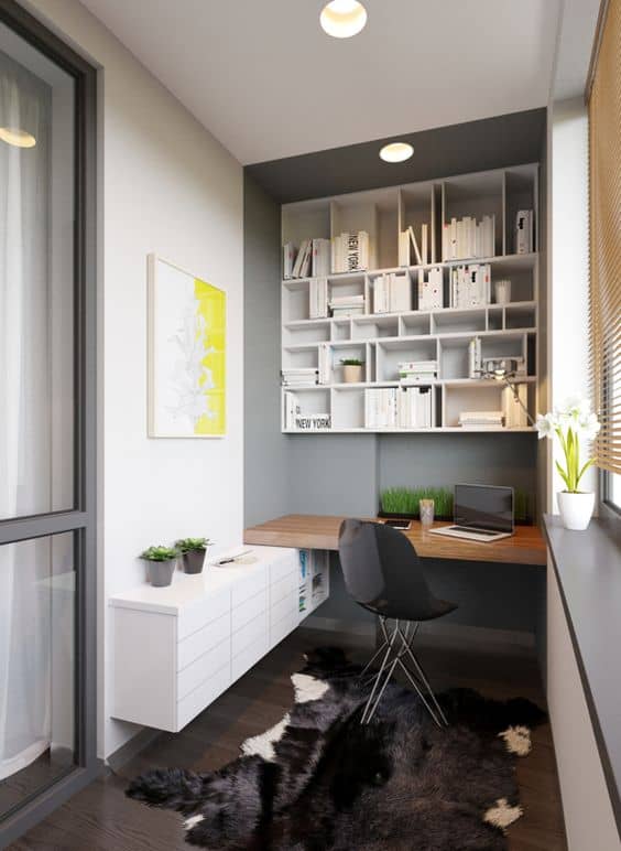 Modern workspace showcasing small office space ideas with a wall-mounted desk, sleek black chair, and modular shelving for organized storage.