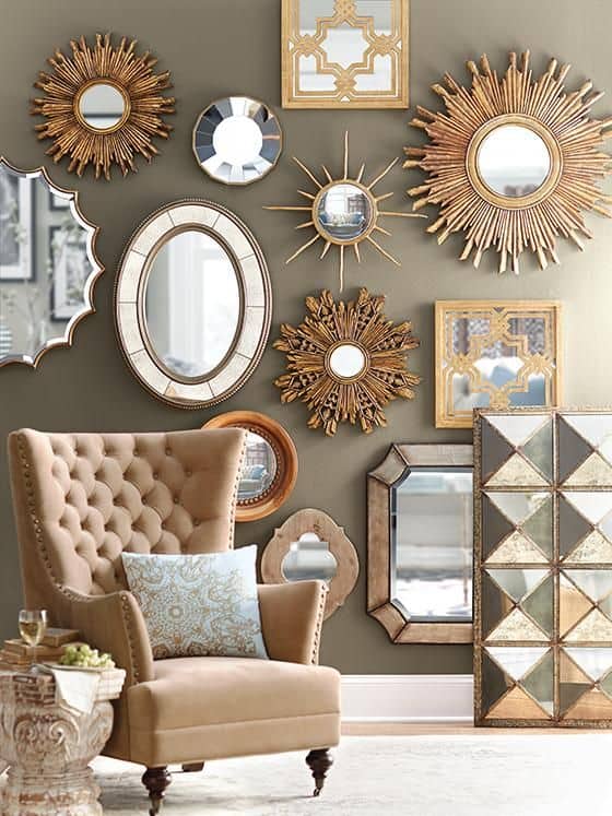 32 Mirror Decorating Ideas - Transform Home With Mirrors 7 Decorative mirrors in various shapes and styles create a striking wall display, reflecting light and enhancing the cozy living room ambiance.