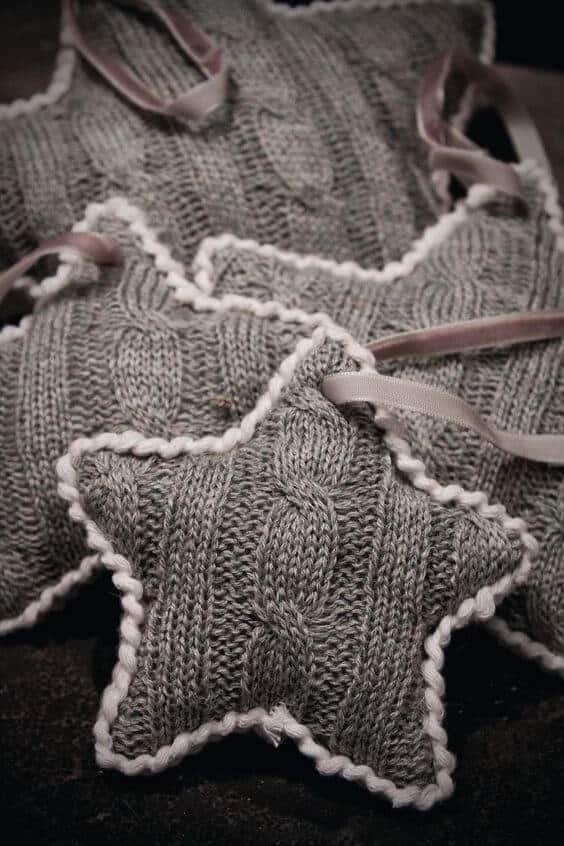 37 DIY Christmas Ornament Ideas For You Unique Decor 15 Decorative knitted DIY Christmas ornaments made from soft gray yarn, star-shaped with a white scalloped border, perfect for festive decor.