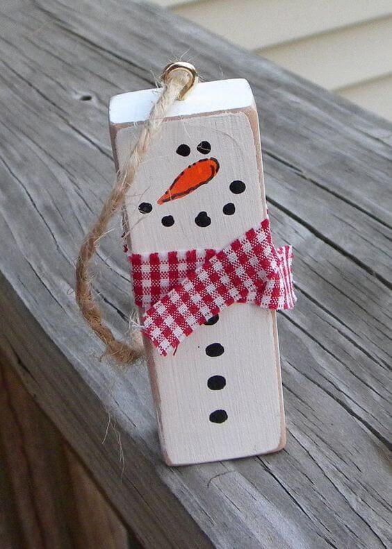 37 DIY Christmas Ornament Ideas For You Unique Decor 16 Handcrafted wooden block ornament featuring a painted snowman with a carrot nose and a cozy scarf, ideal for festive decorations.