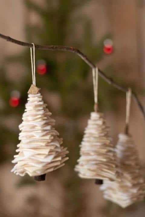 37 DIY Christmas Ornament Ideas For You Unique Decor 5 Handcrafted tree ornaments made of layered fabric in a neutral palette, each 6 inches tall, suspended from twine on a branch, complementing a Christmas tree.