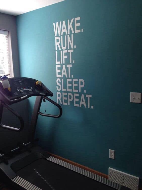 36 Home Gym Ideas - Layouts For Your Perfect Workout Spot 12 Home gym featuring a treadmill against a calming teal wall with motivational phrases. Bright, spacious layout ideal for workouts.