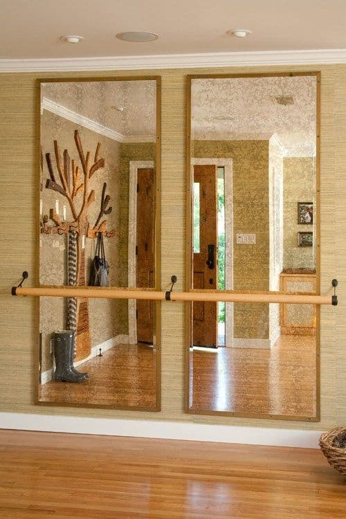 36 Home Gym Ideas - Layouts For Your Perfect Workout Spot 5 Two large rectangular mirrors on a textured wall, with a wooden barre below, create a spacious and inviting home gym decor.