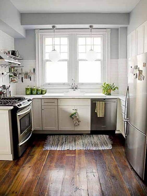 Small kitchen remodel featuring white cabinetry, stainless steel appliances, and efficient layout with natural light and clever storage solutions.