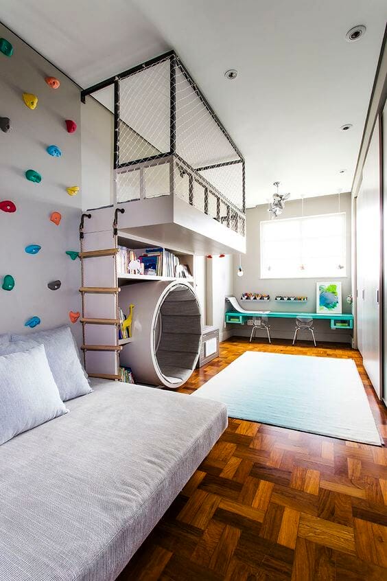 Modern basement playroom with climbing wall, raised sleeping area, reading nook, and vibrant decor, perfect for kids' activities.