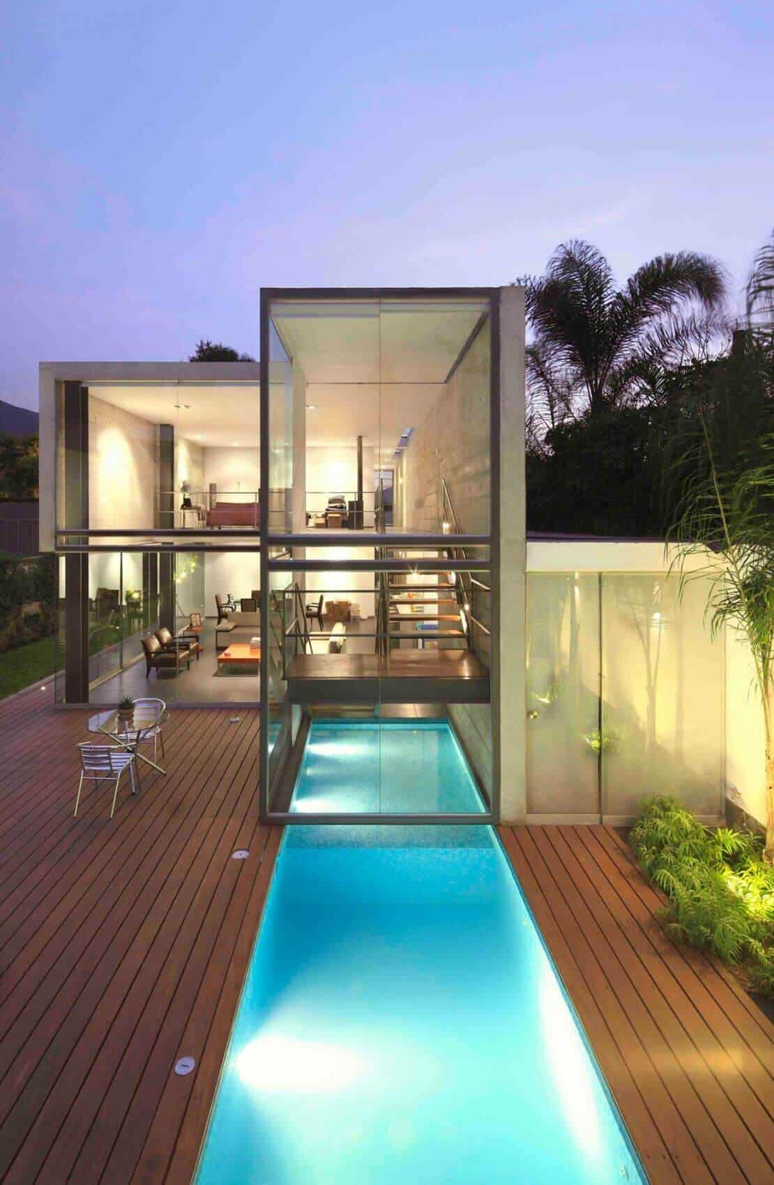 Modern deck design with large glass panels, a sleek swimming pool, and a seamless indoor-outdoor living space, ideal for warm climates.
