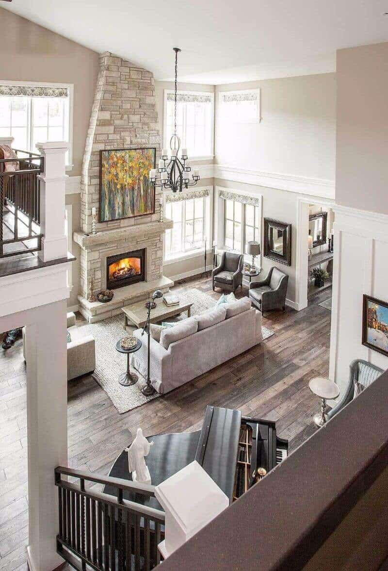 27 Contemporary Living Room Ideas for a Modern Haven Space 18 Expansive contemporary living room with vaulted ceiling, stone fireplace, large windows, dark hardwood flooring, and elegant chandelier.