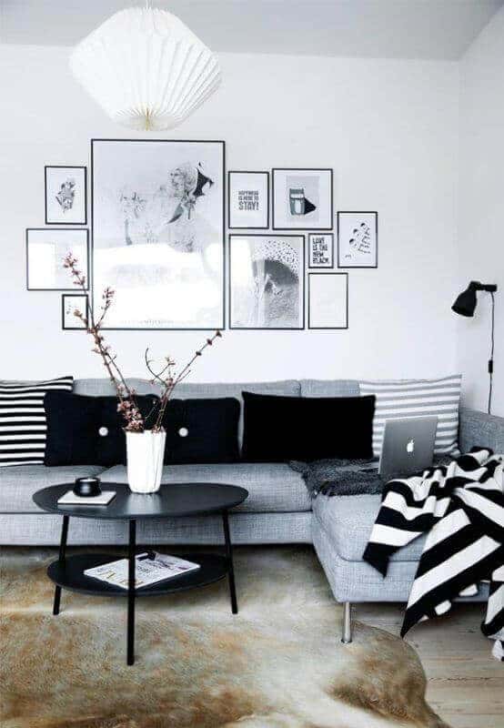 27 Contemporary Living Room Ideas for a Modern Haven Space 24 Minimalist living room with gray sectional sofa, black circular coffee table, and gallery wall of framed art. Modern floor lamp and neutral rug enhance the cozy atmosphere.