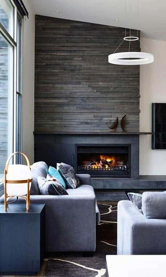 27 Contemporary Living Room Ideas for a Modern Haven Space 26 Modern living room with a sleek gray stacked stone wall, plush gray sofa, minimalist decor, and large windows for natural light.