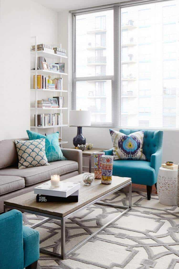 27 Contemporary Living Room Ideas for a Modern Haven Space 6 Contemporary living room features a gray sectional sofa with turquoise pillows, geometric rug, and a glass coffee table, illuminated by natural light.