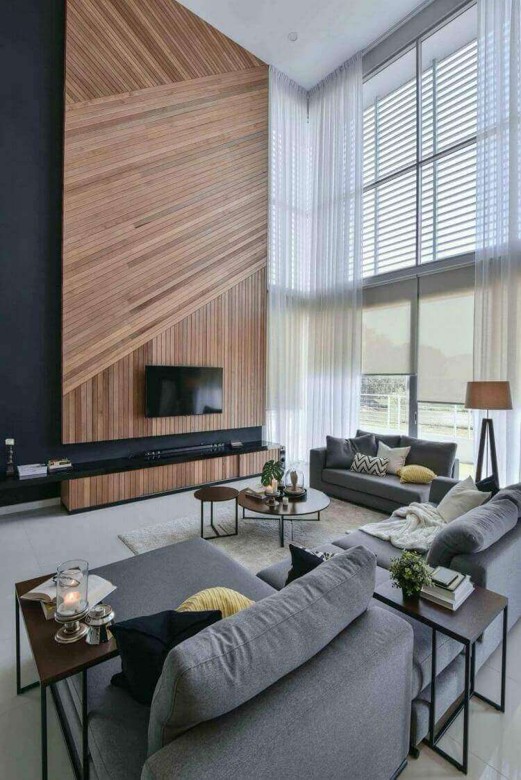 27 Contemporary Living Room Ideas for a Modern Haven Space 8 Contemporary living room with high ceiling, wooden accent wall, gray sofas, round coffee table, and large floor-to-ceiling windows.