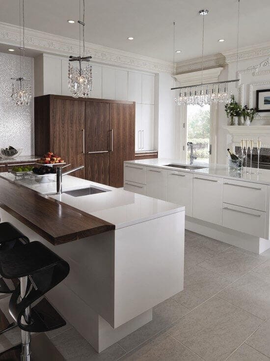 Modern kitchen with two islands, featuring glossy white quartz countertops, high-gloss white cabinets, and walnut accents in a spacious layout.
