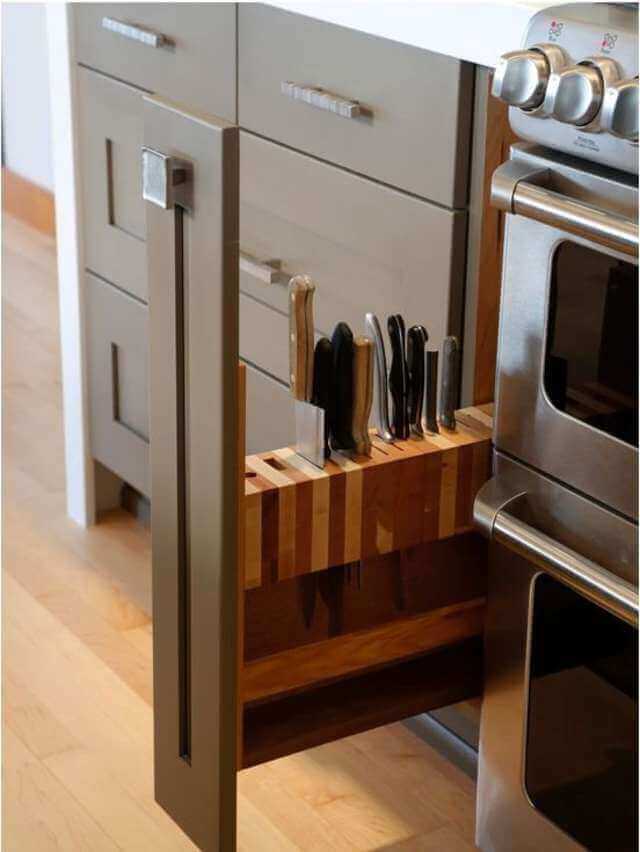 Sleek pull-out drawer for kitchen knife storage, crafted from wood and metal, featuring a wooden knife block for organized, efficient use.