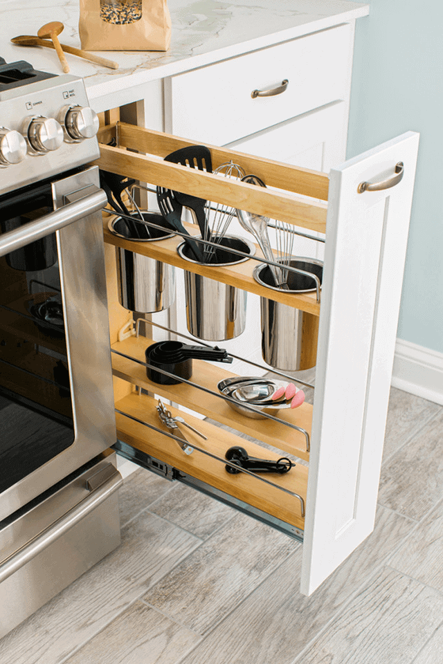 Space-efficient pull-out drawer showcasing solid wood construction with sections for utensils, enhancing kitchen organization and maximizing storage.