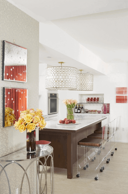 Modern kitchen with an 8x4 feet white marble island, rich walnut cabinetry, acrylic bar stools, and honeycomb pendant lighting.